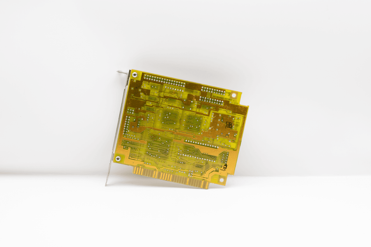 a single shiny computer chip sitting inside a rusty vintage lunchbox