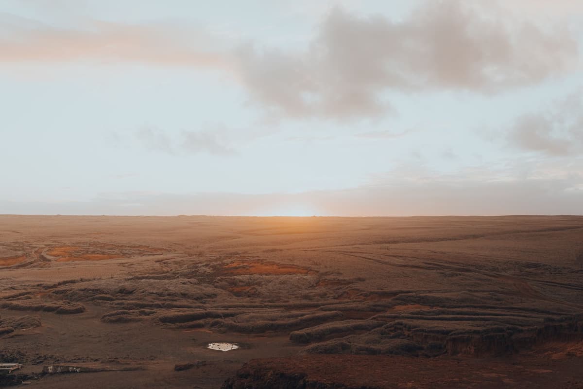 a massive white desalination pipe stretching across a dry orange desert