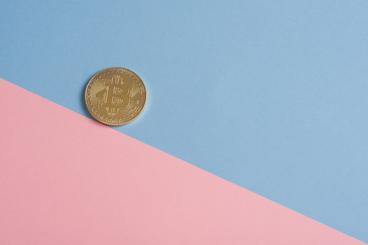 a single gold coin resting on a slab of dull grey lead