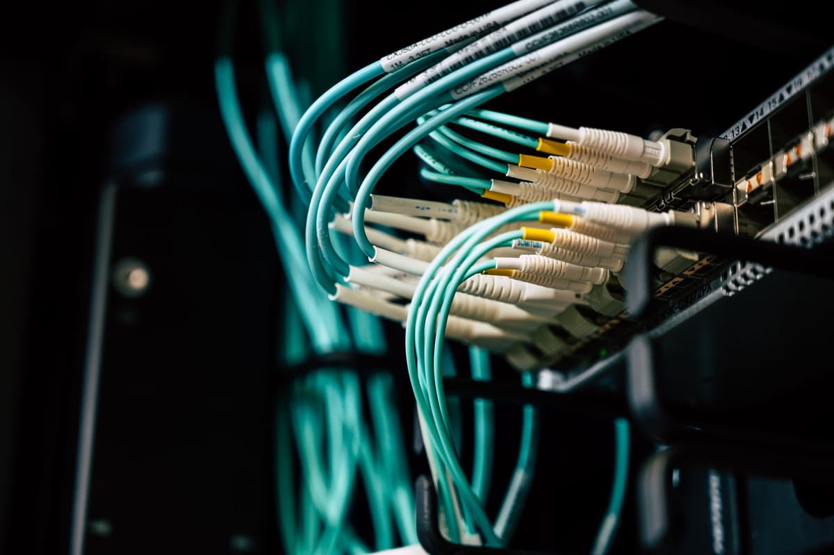 a high-end server rack glowing in a dark room