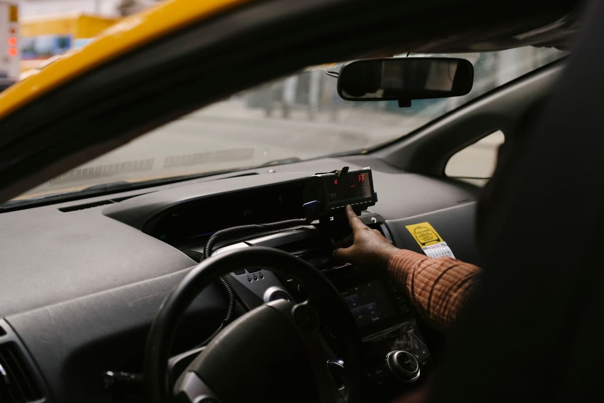 a hand hovering over a featureless glass dashboard