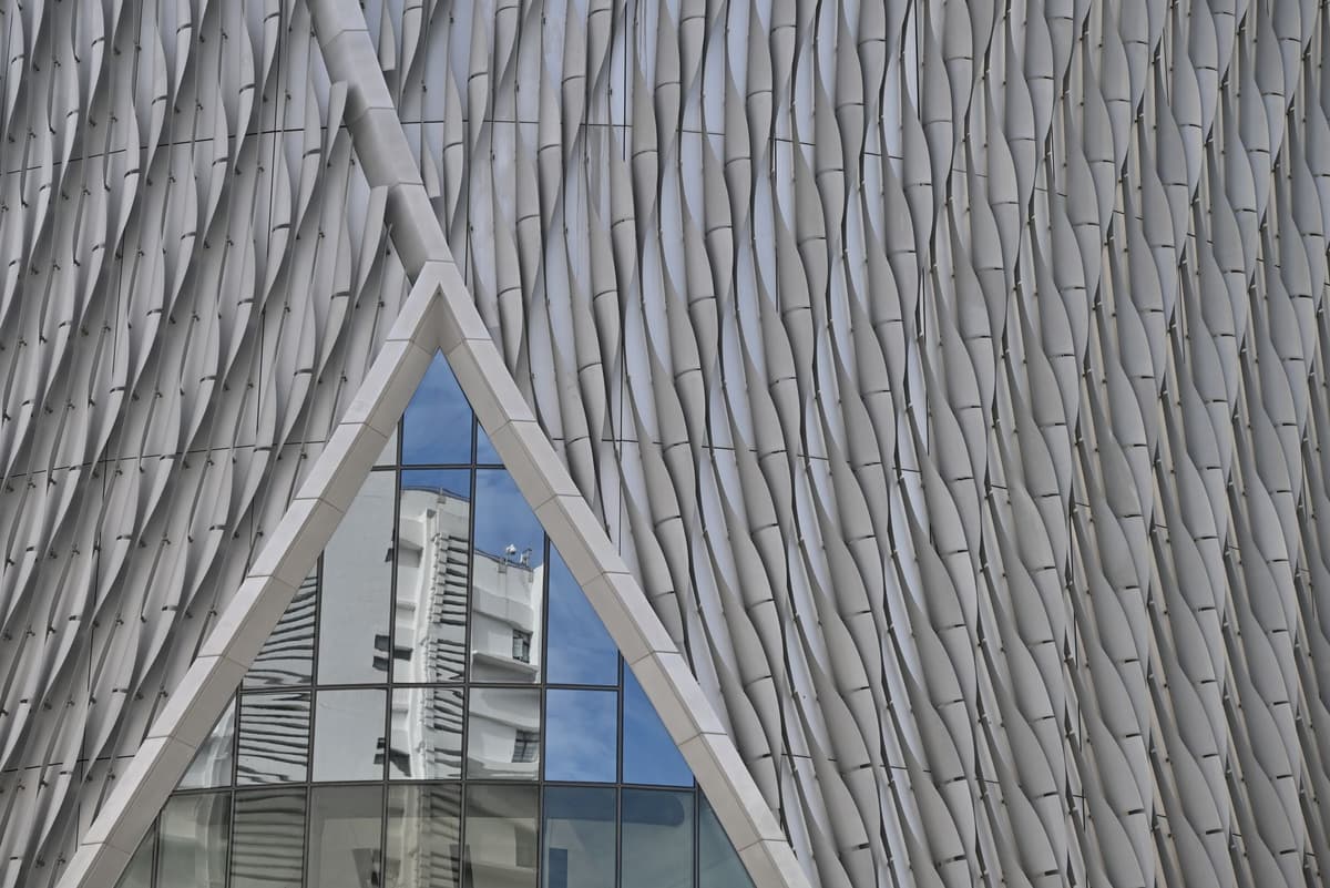 a jagged metal building facade with sharp triangular panels