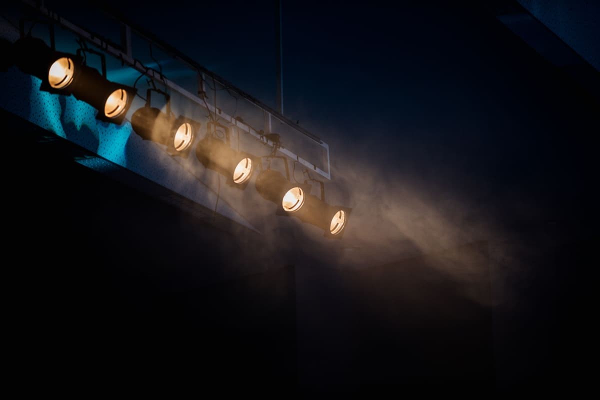 a single bright spotlight hitting a dark suburban street
