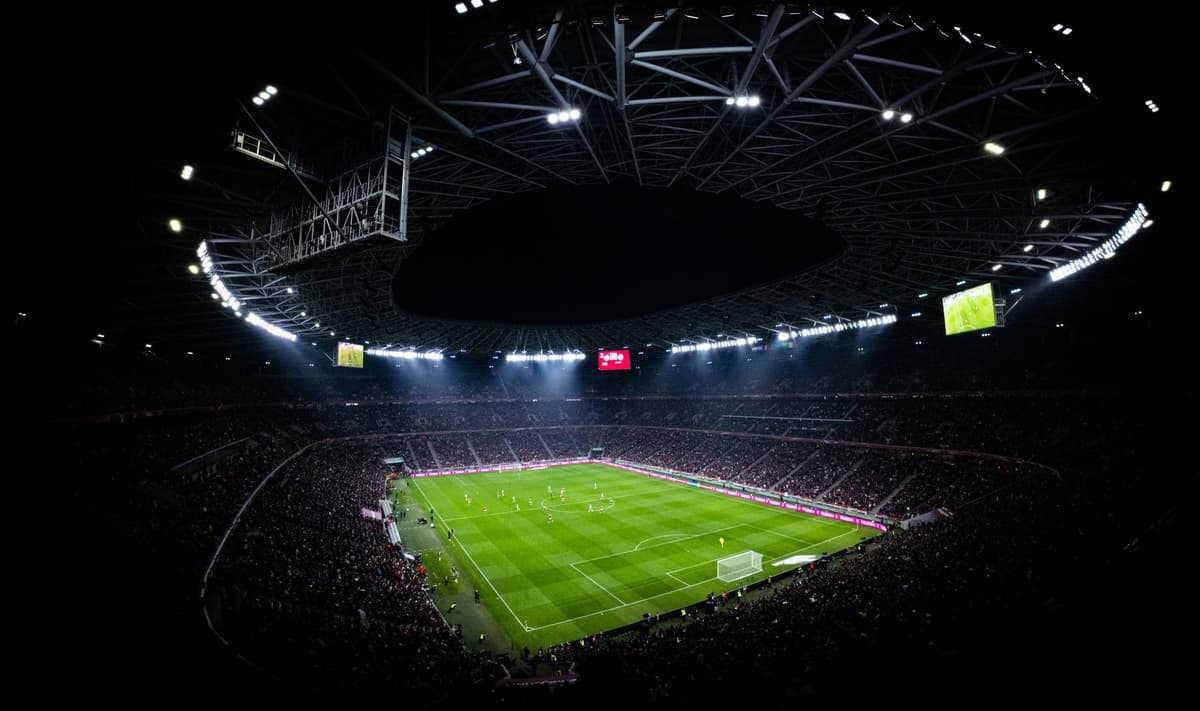 a high-tech biometric scanner reflecting a soccer stadium lights