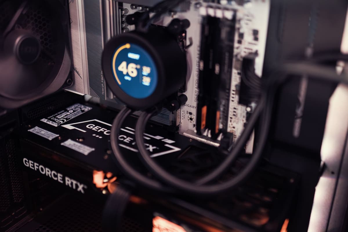 a tiny dusty graphics card sitting next to a massive modern triple-fan GPU