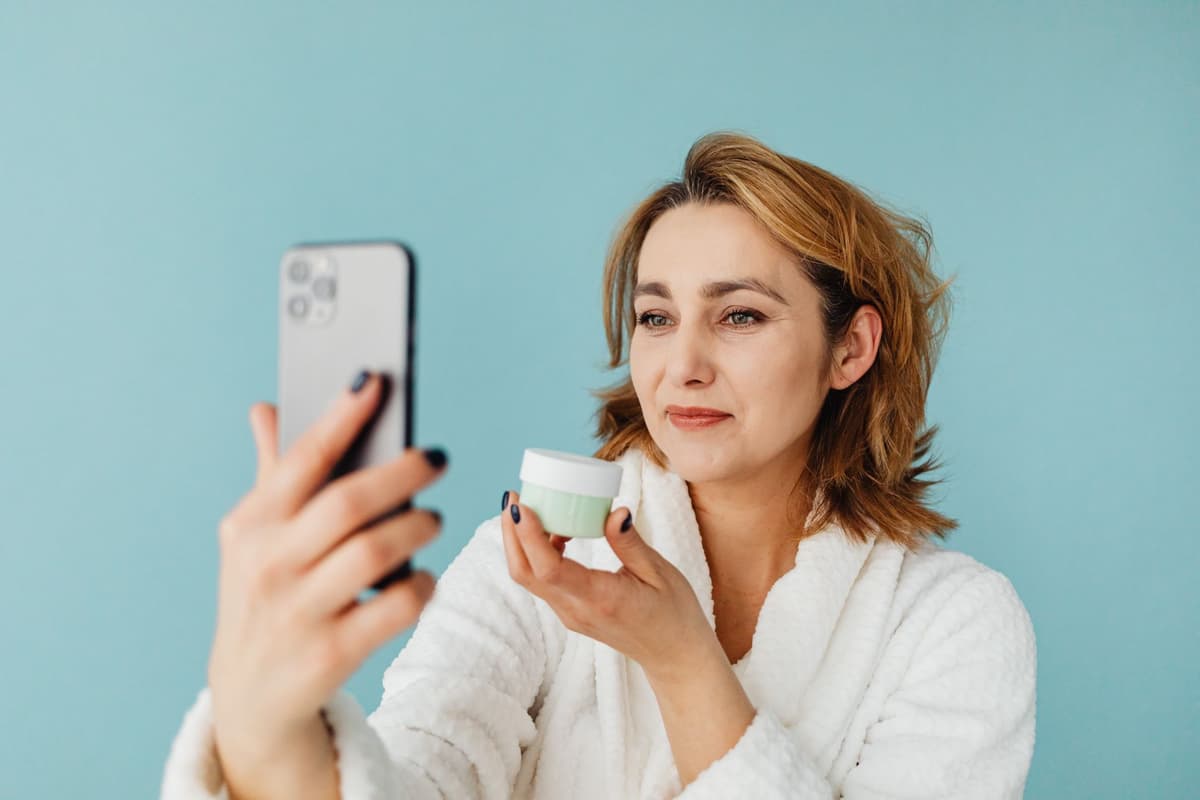 a person holding a smartphone reflecting a barcode across their face