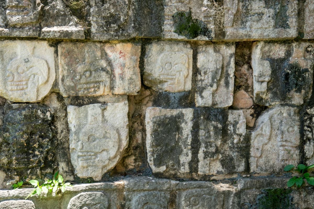 close up of weathered red glyphs on stone