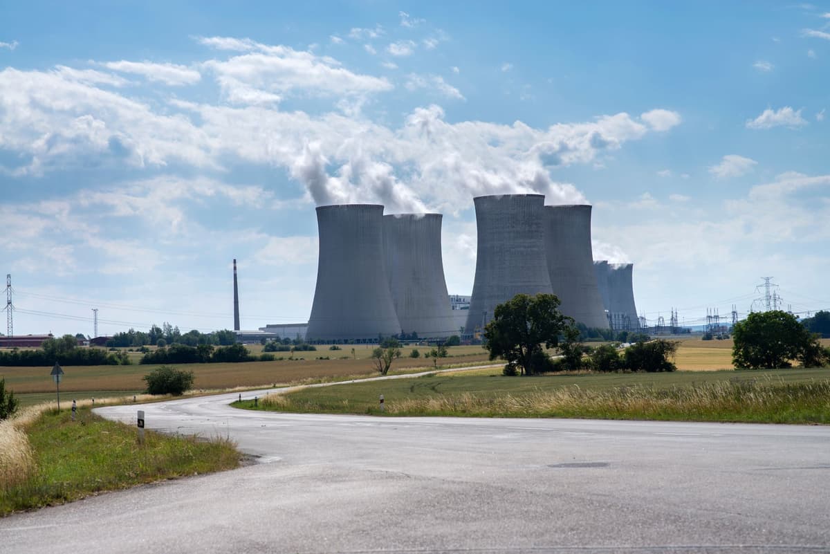 nuclear cooling towers behind a sleek warehouse building
