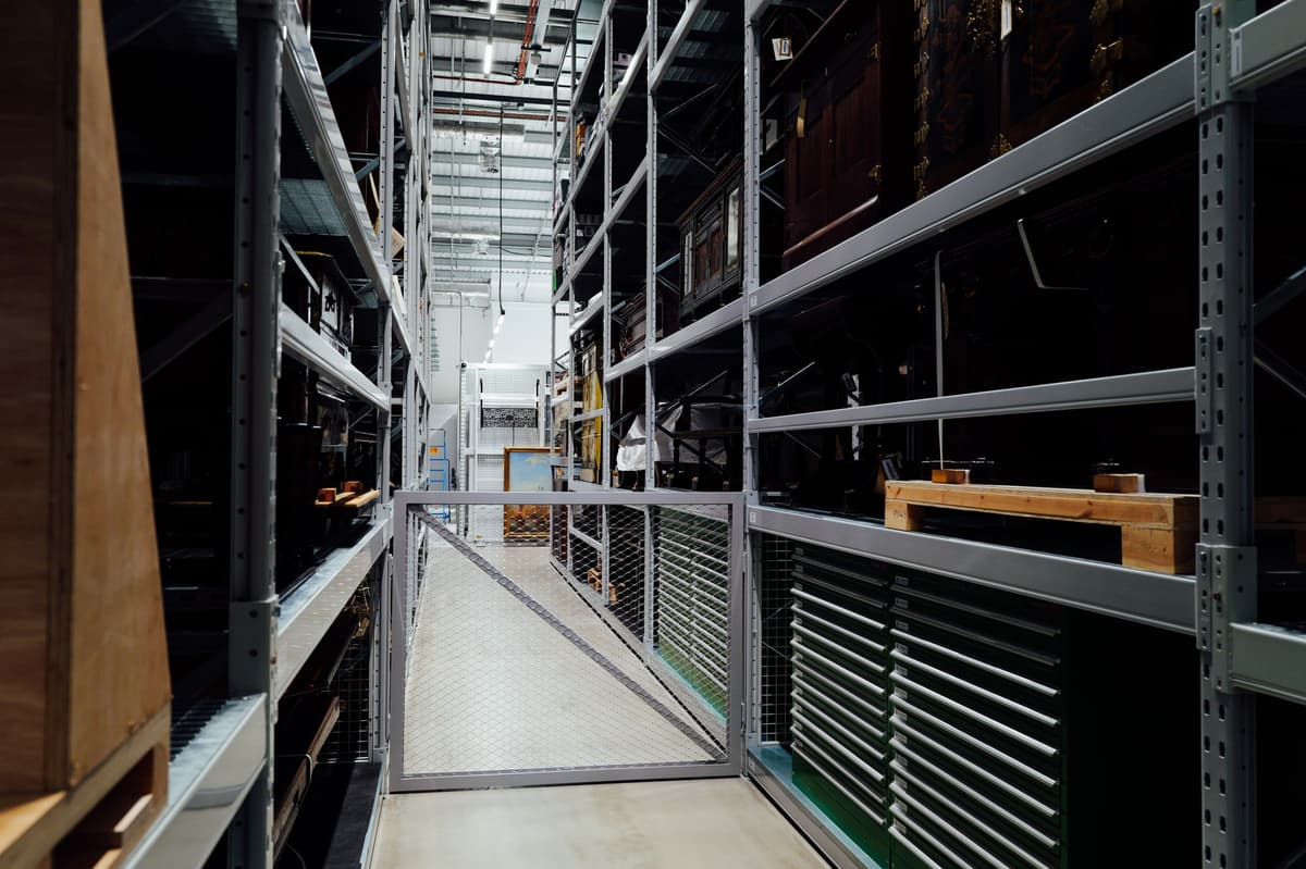 a single white server rack standing alone in a vast empty warehouse
