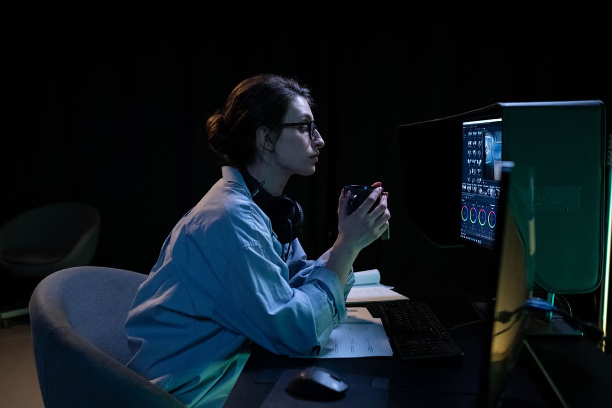 a person whispering into a glowing computer monitor