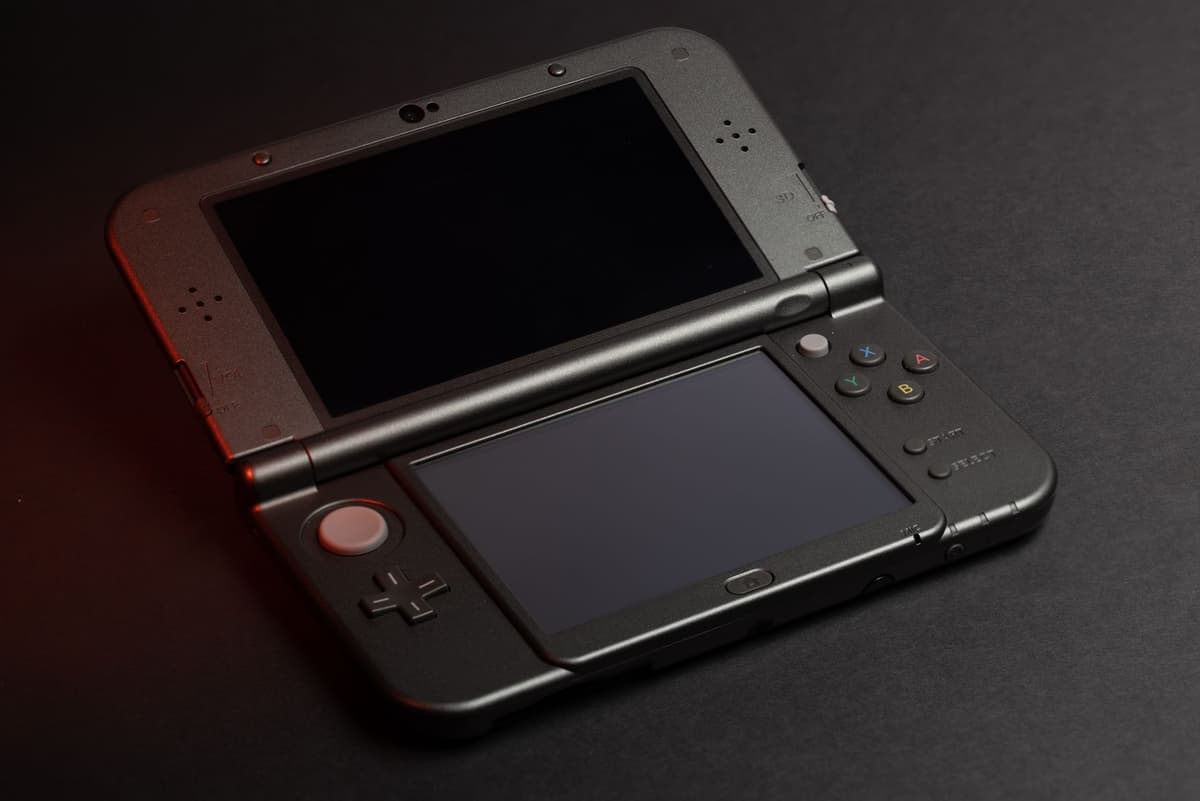 a small handheld electronic device with a grainy monochrome screen on a wooden table