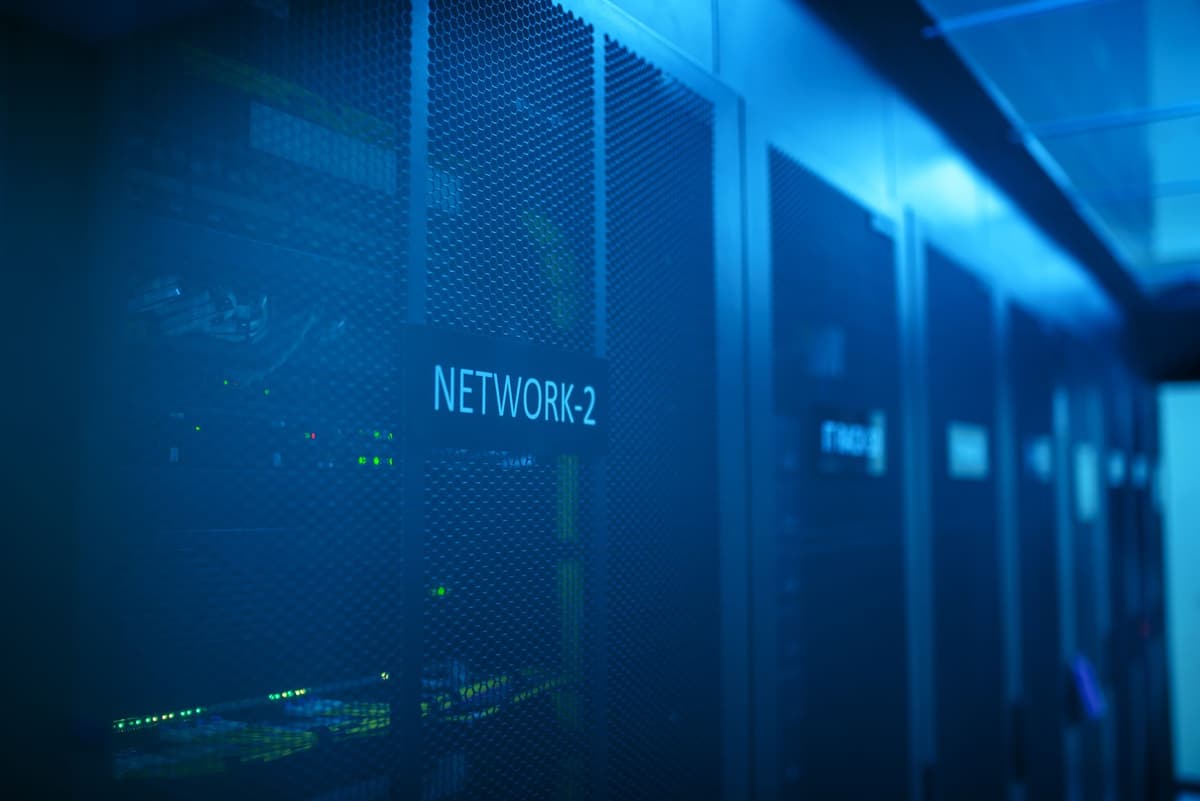a single glowing server rack in a dark empty concrete room