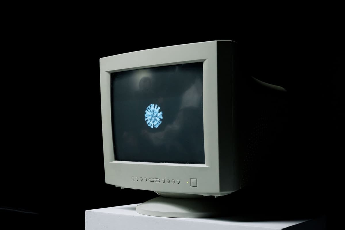 a vintage CRT monitor displaying pixelated comic panels