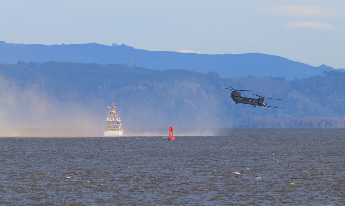 Navy ship next to a massive water geyser explosion