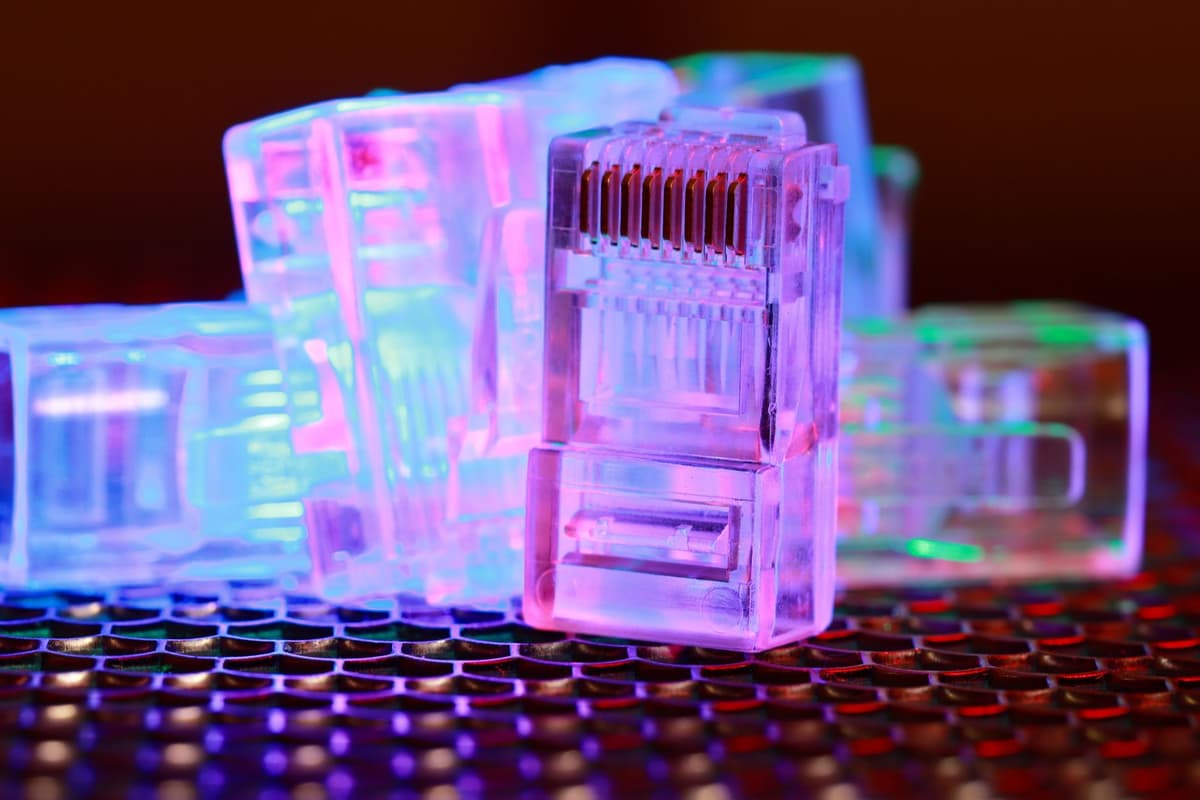 a high-end desktop computer glowing in a dark room with disconnected ethernet cables