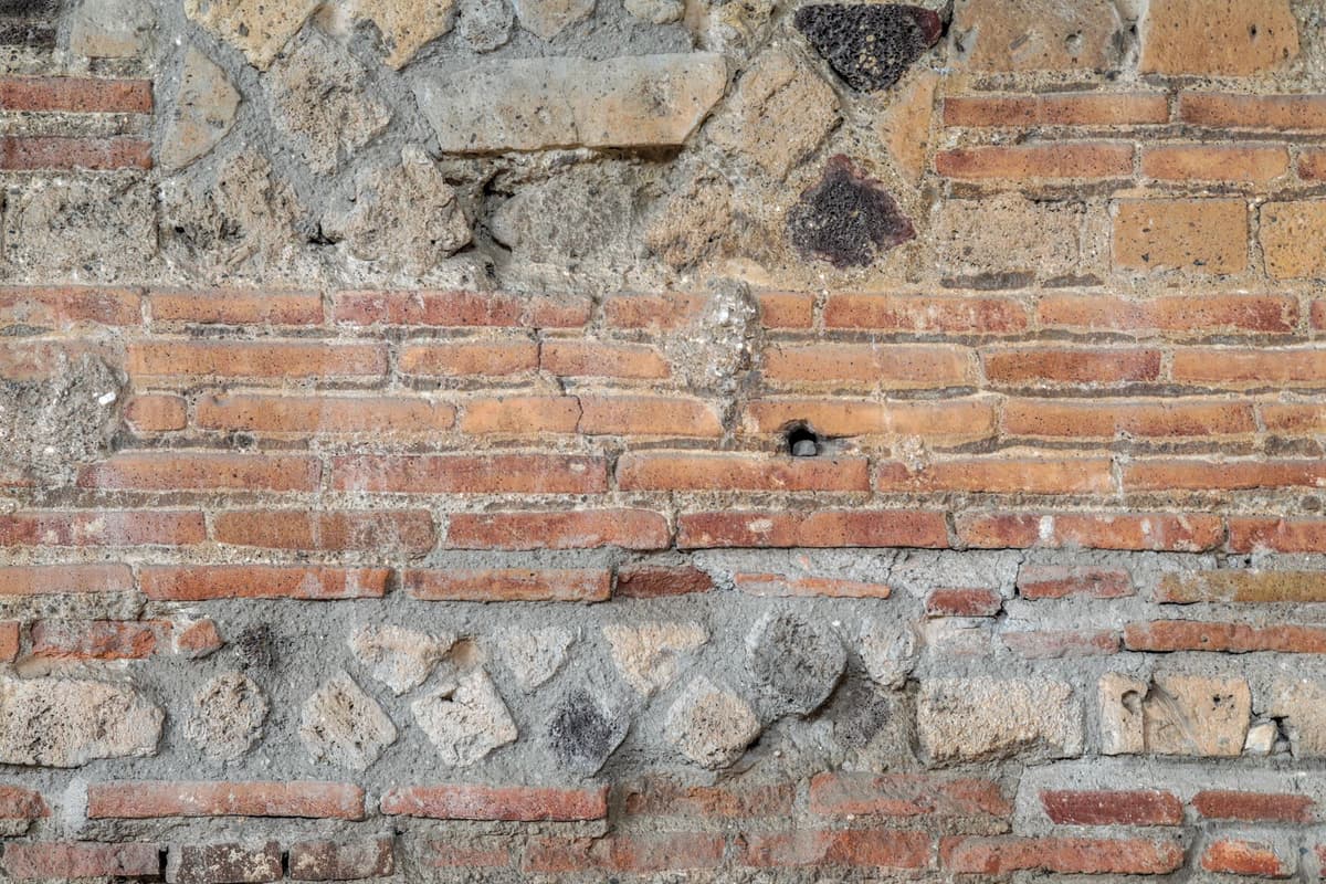 a row of stone holes in a Roman latrine