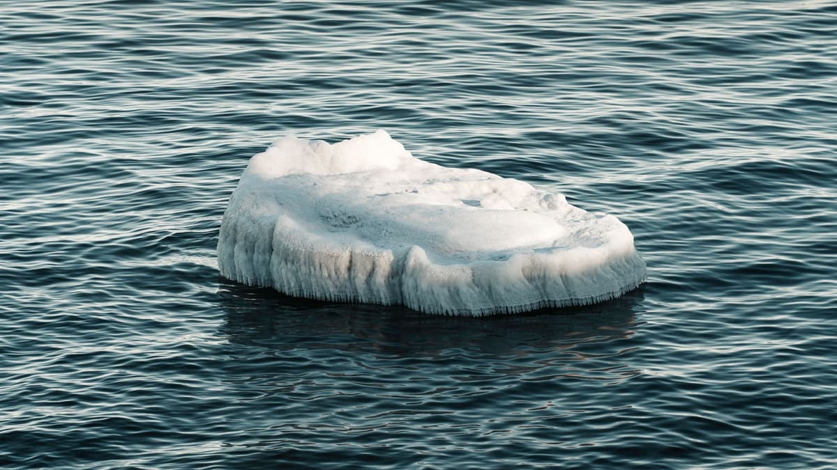a single block of ice melting on a heated metal plate
