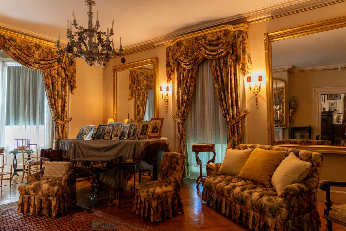 Victorian parlor crammed with heavy furniture and velvet drapes