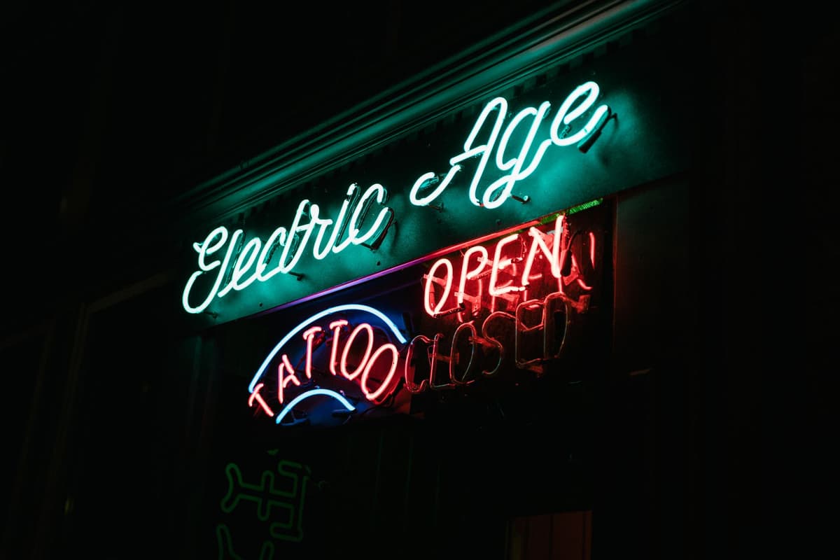 a dusty dictionary sitting next to a glowing neon sign