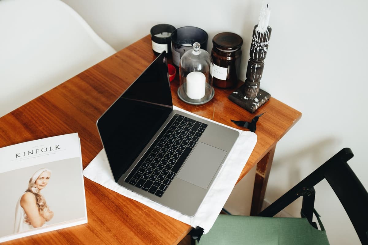 a dusty black netbook sitting on a clean wooden desk