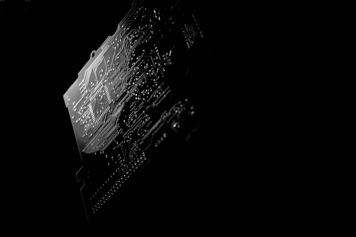 a small circuit board glowing in a dark room