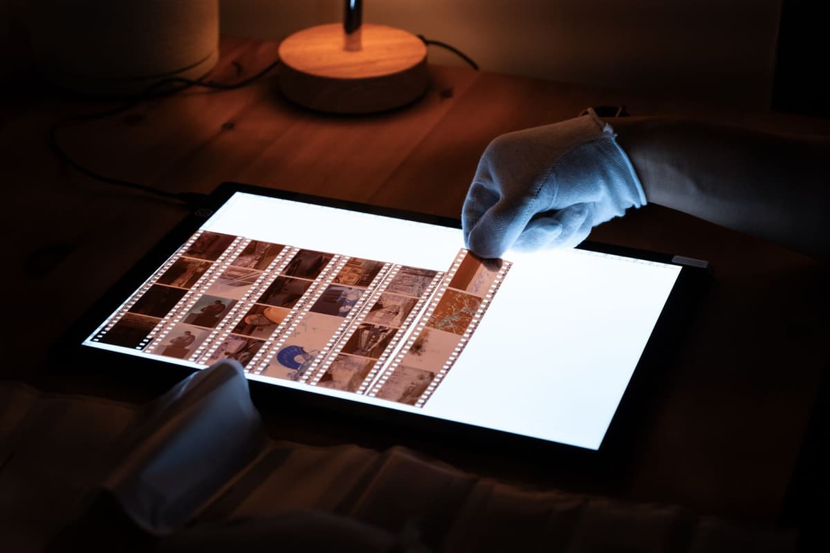 a researcher comparing a star chart to a film strip