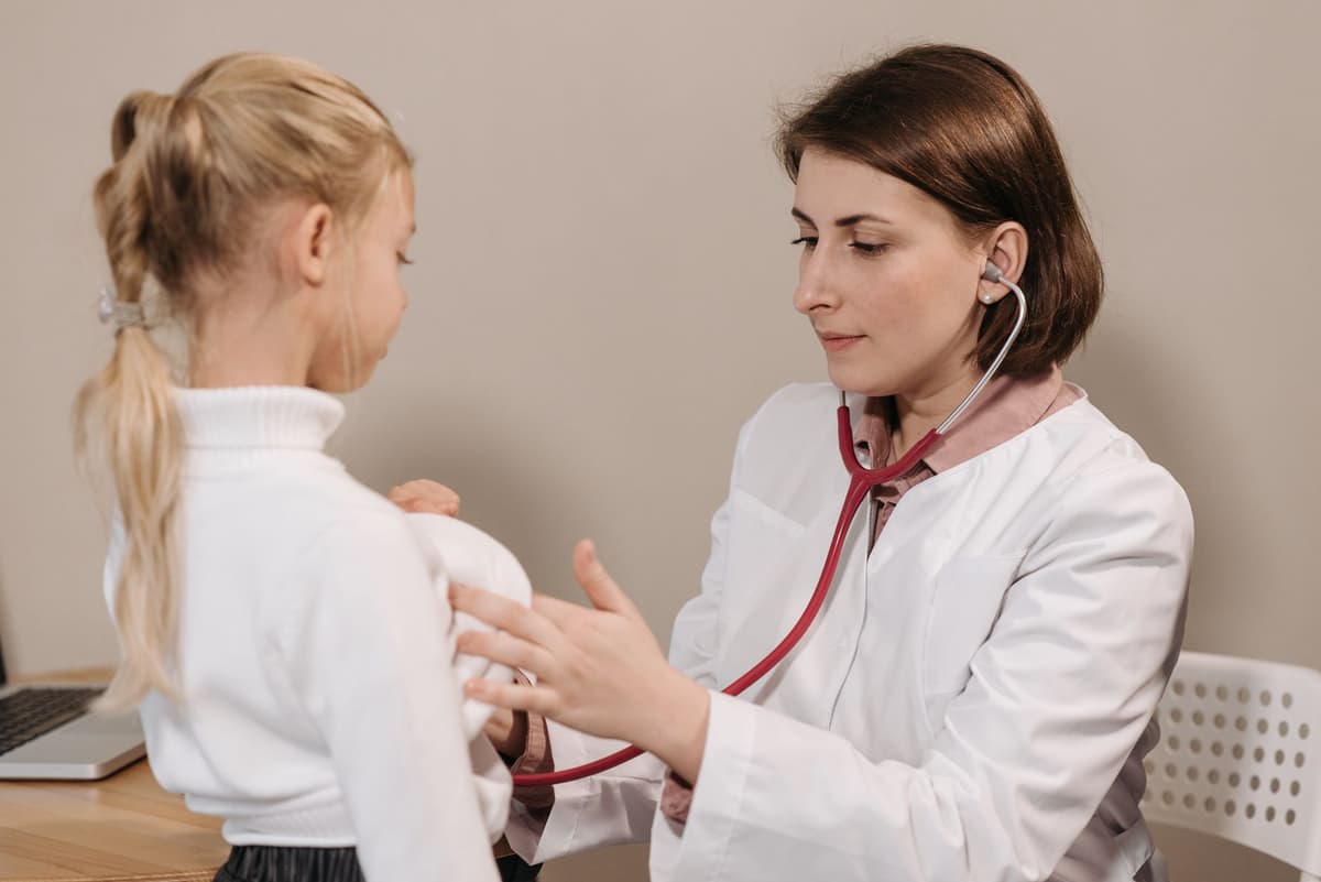 a golden retriever wearing a white lab coat and stethoscope