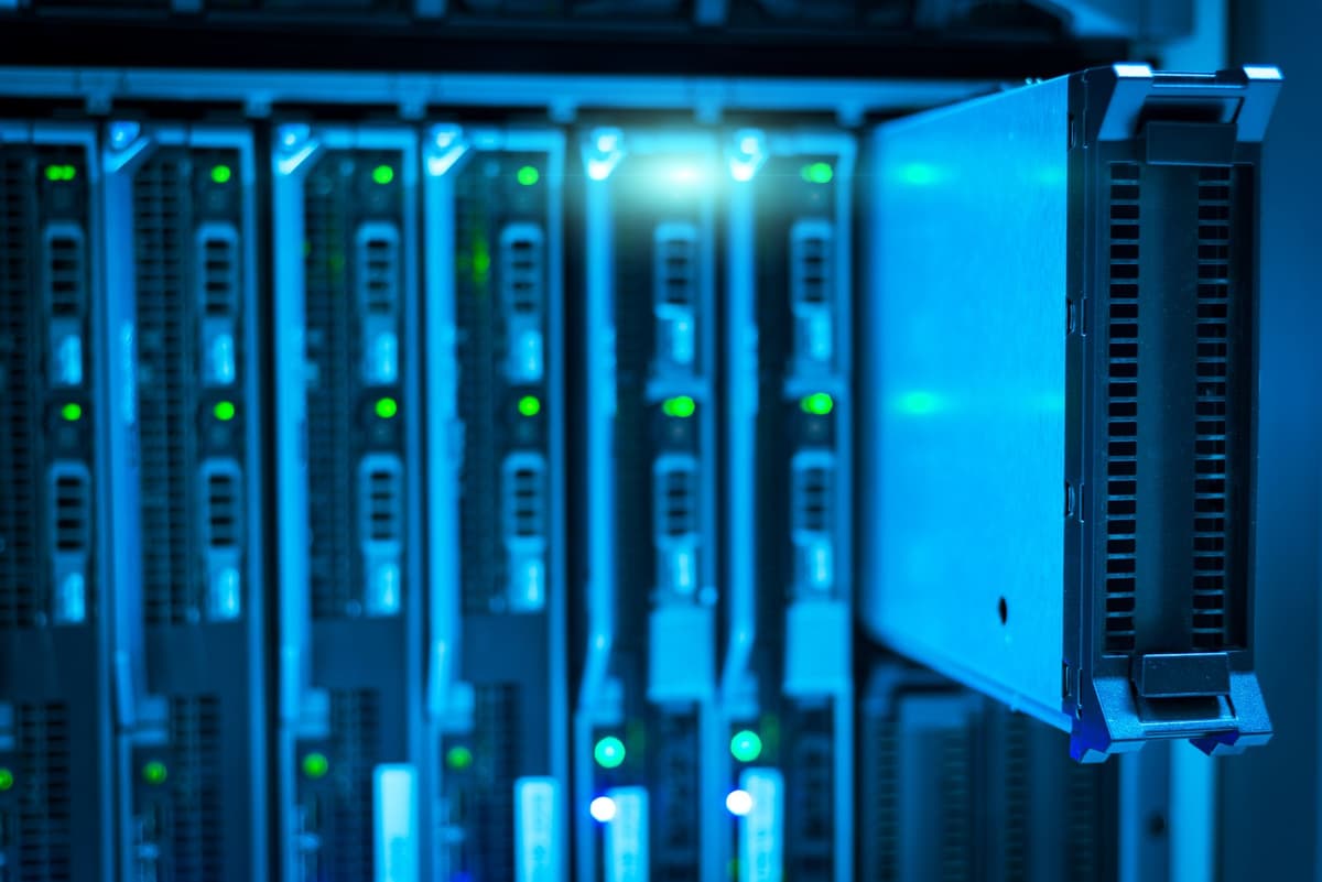 a server rack glowing with green lights in a dark room