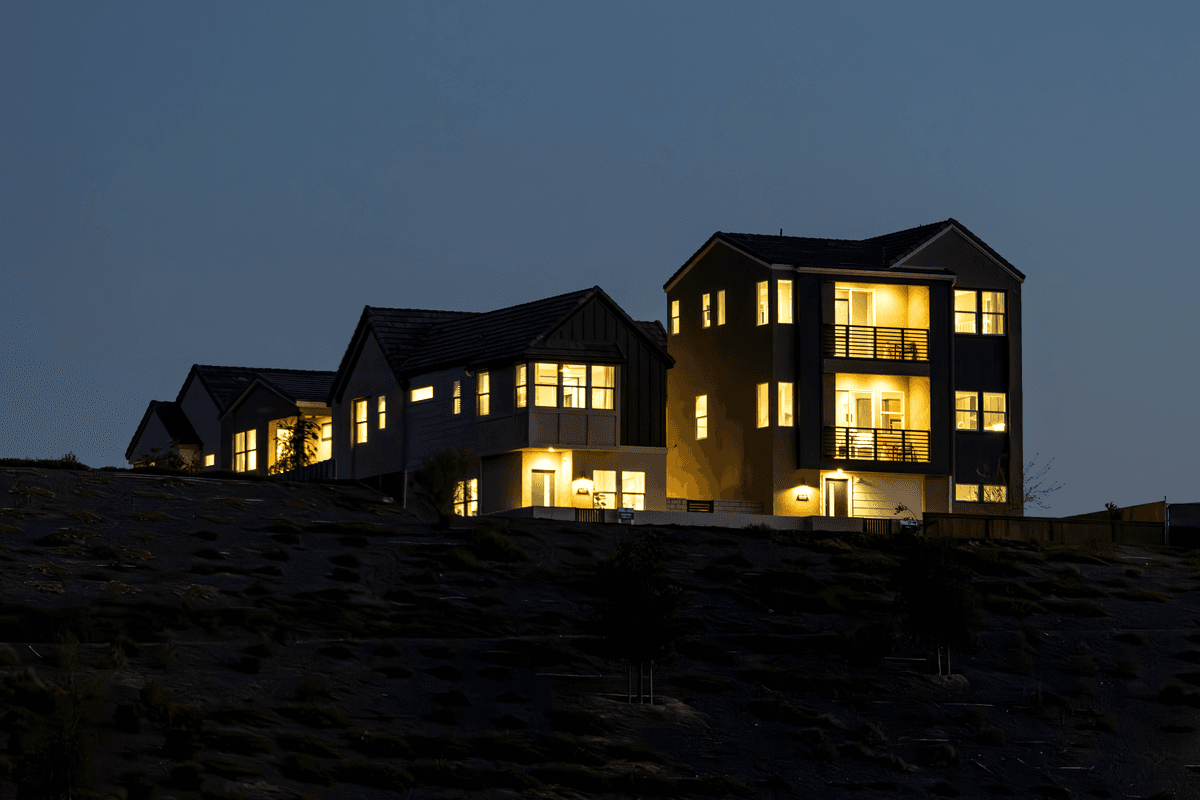 a row of identical white suburban houses glowing like radioactive isotopes