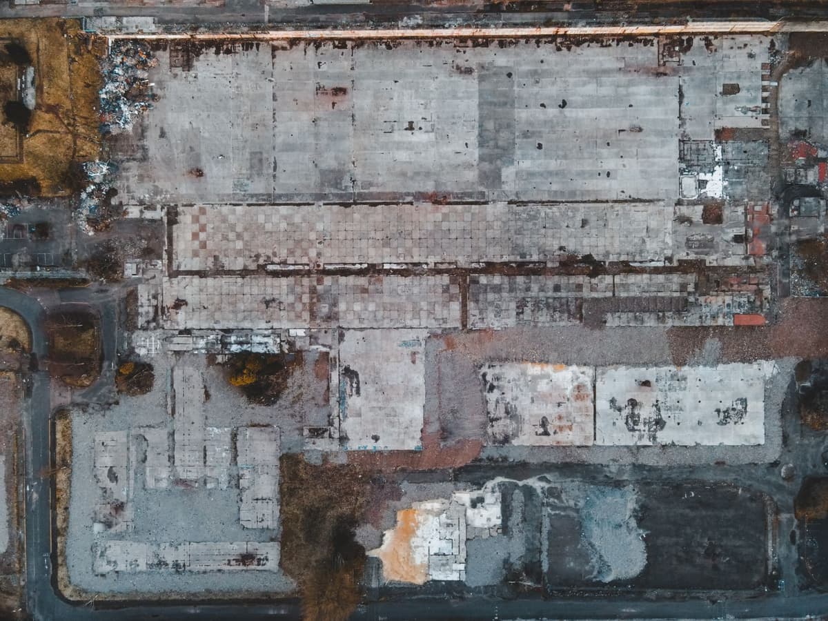 a construction crane hovering over a sprawling demolished parking lot