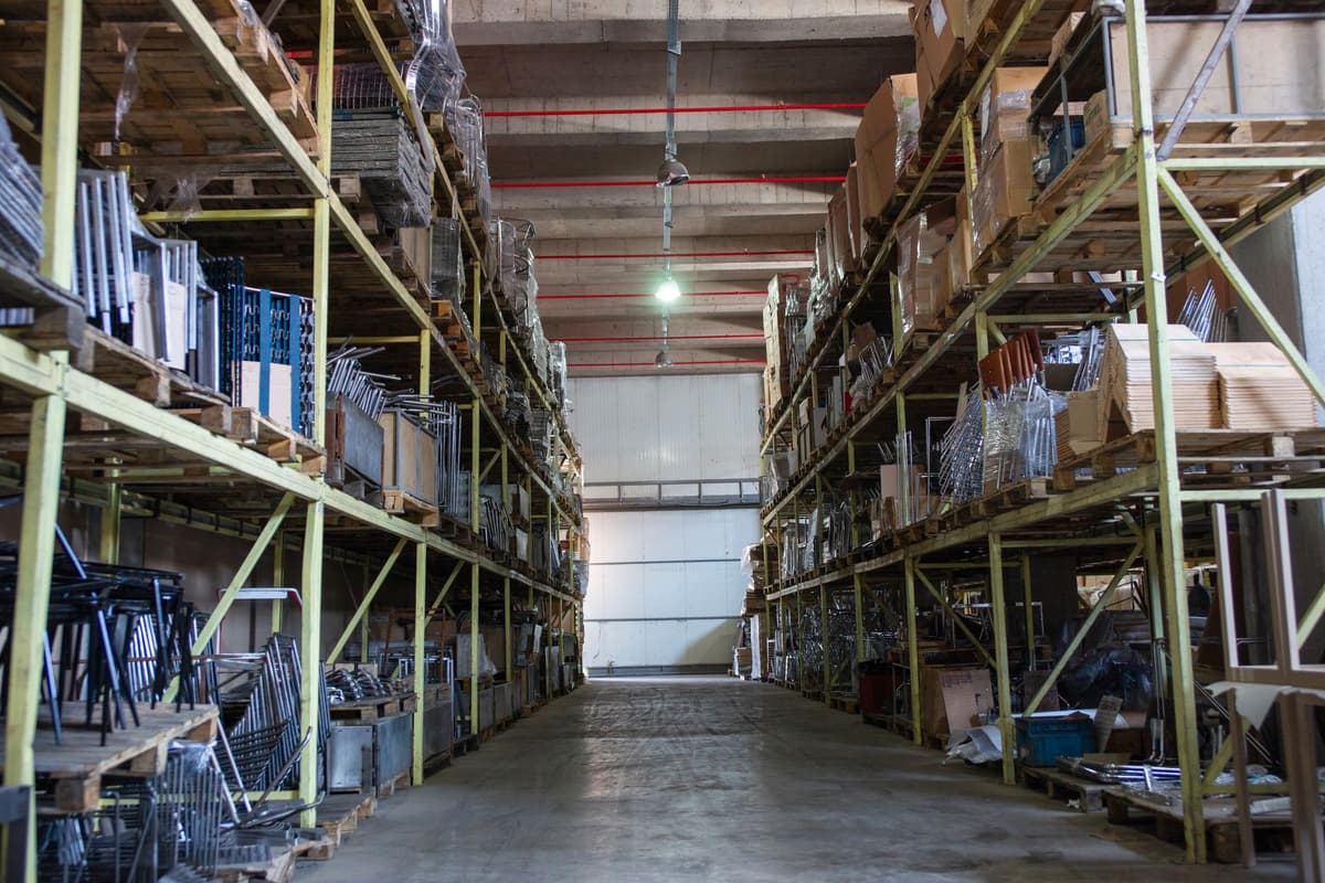 a single glowing server rack in an otherwise dark empty warehouse