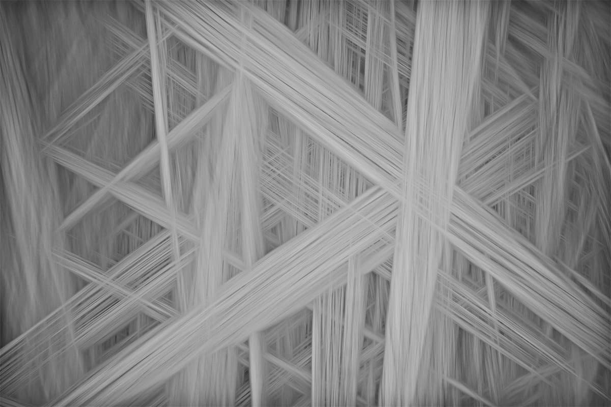 a close-up of a complex honeycomb structure made of glowing fiber optics