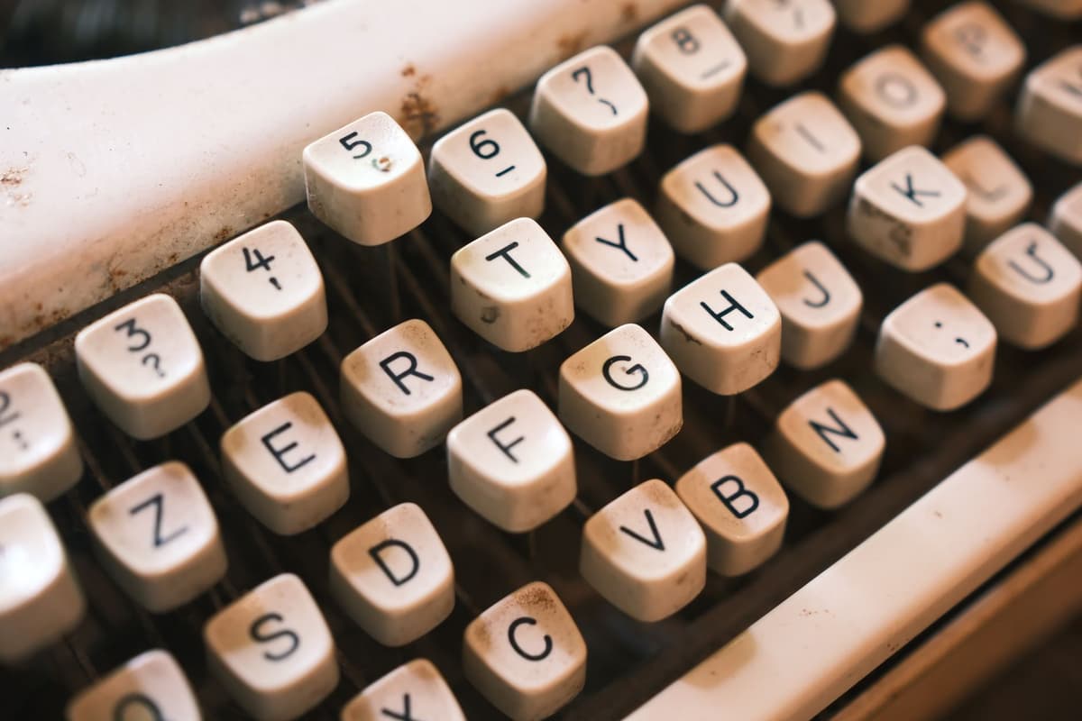 a close-up of a dusty computer keyboard with one missing key