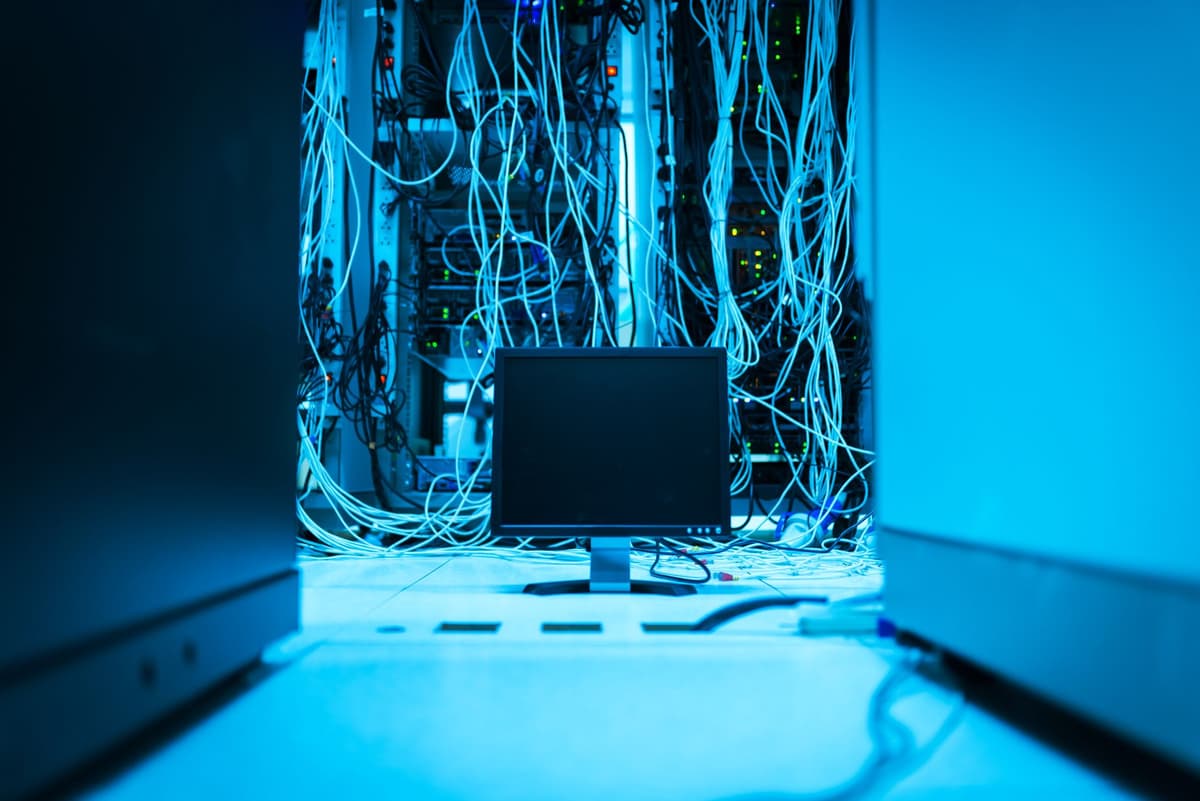 a server rack glowing with orange heat in a dark room