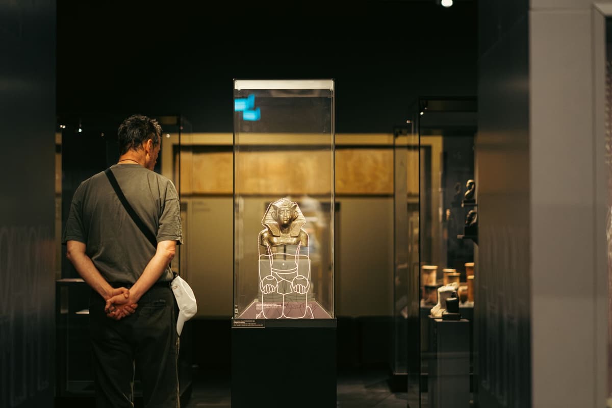 a dusty calculator inside a glass museum display case